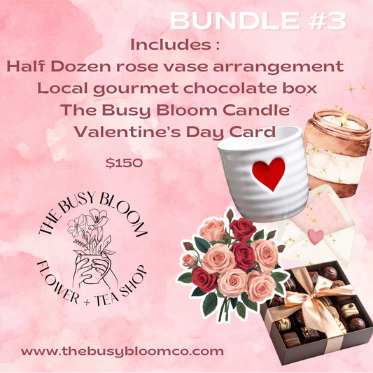 Promotional image of a Valentine's Day bundle with a rose vase arrangement, chocolate box, candle, and card on a pink background.